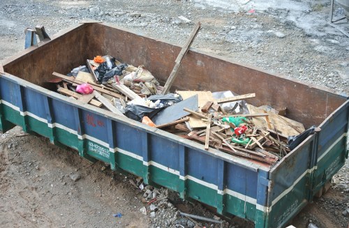 People disposing of furniture at a Barbican recycling center