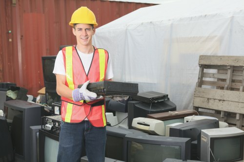 Workers loading garden waste onto a truck during a yard clearance